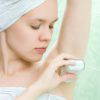 beauty young woman in bath room with deodorant