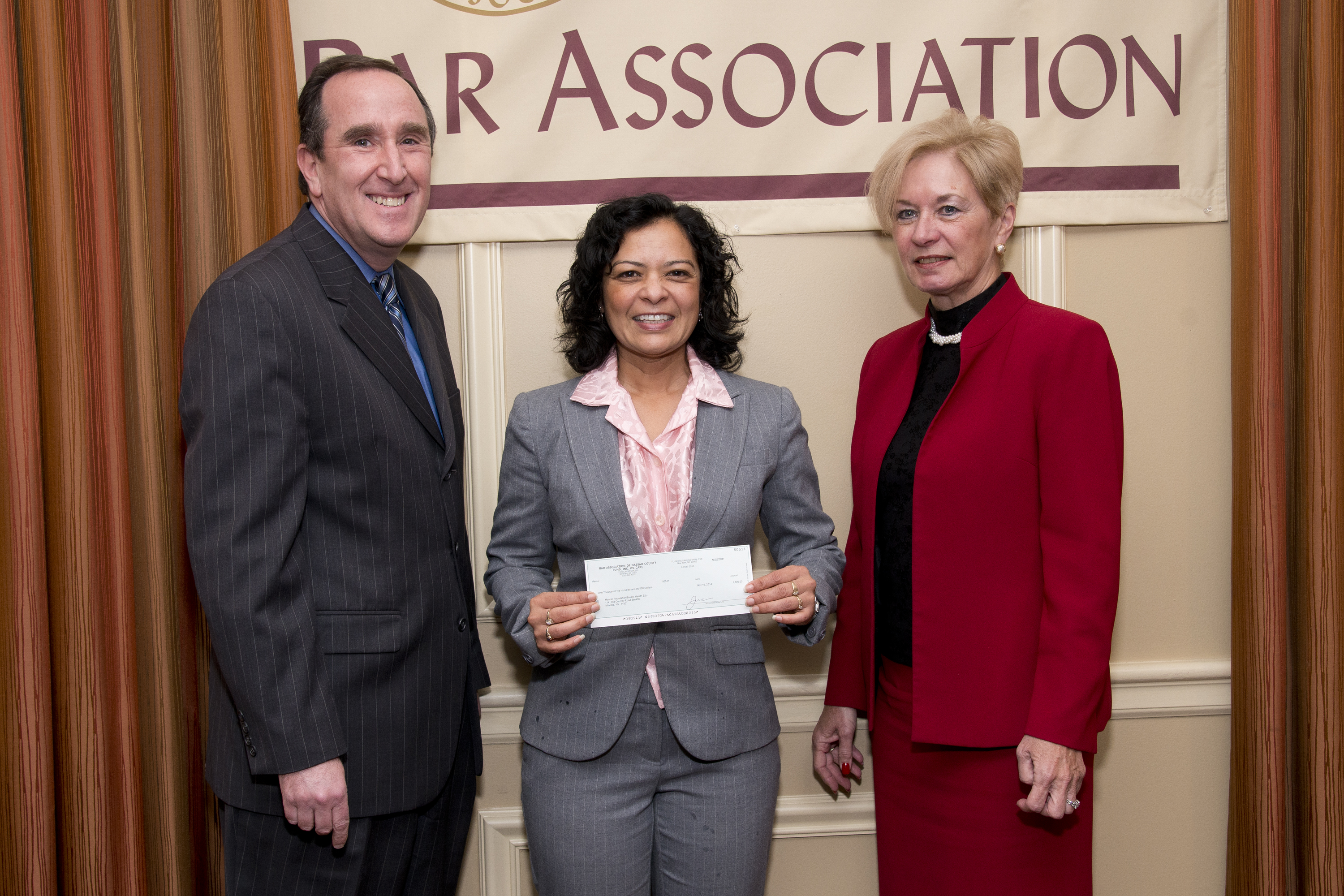 Maurer Foundation Executive Director Susan Samaroo accepts the check from Peter Levy & Kathleen Wright of the Nassau County Bar Association.