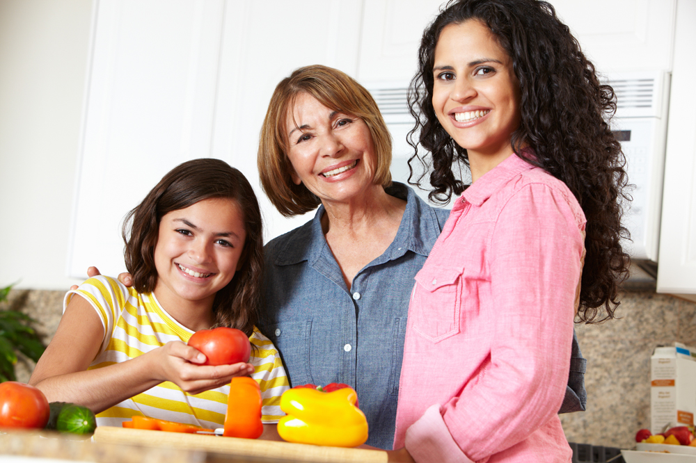 Daughter, mother, and grandmother prepare food