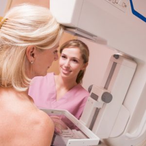 Nurse Assisting Patient Undergoing Mammogram